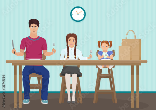Kids waiting for dinner in the kitchen. Holding a spoon and fork in the hand. Hungry children kids waiting tasty food.