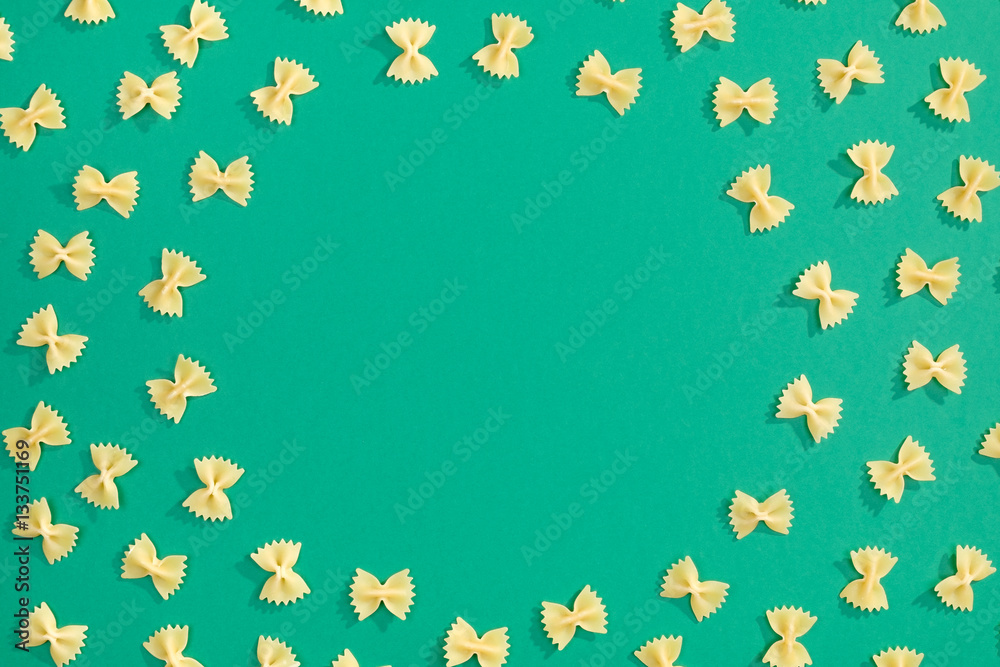 Frame from wheat pasta on green background