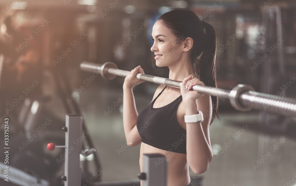 Athletic woman training with a barbell Athletic woman training with a barbell