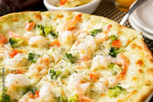 shrimp pizza on table