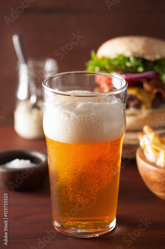 pint glass of india pale ale beer and fastfood