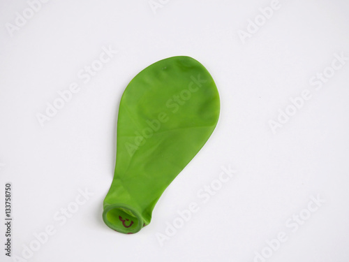 Green deflated balloon isolated