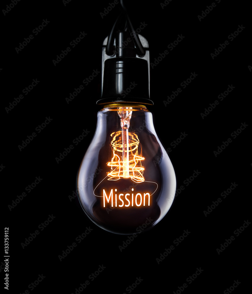 Hanging lightbulb with glowing Mission concept.
