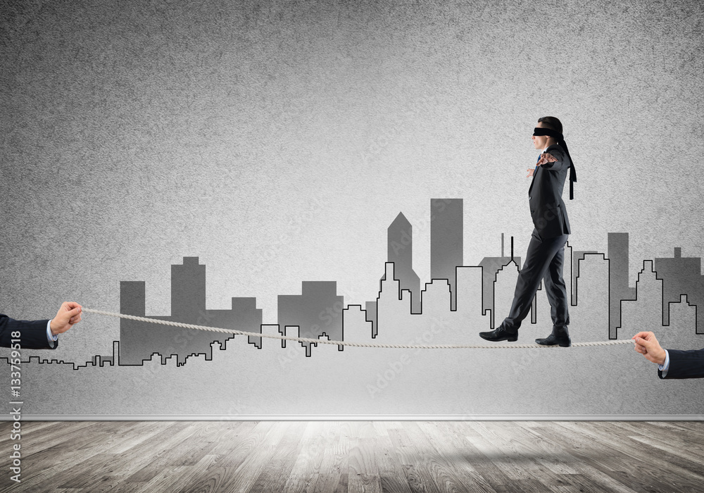 Business concept of risk support and assistance with man balancing on rope Business concept of risk support and assistance with man balancing on rope
