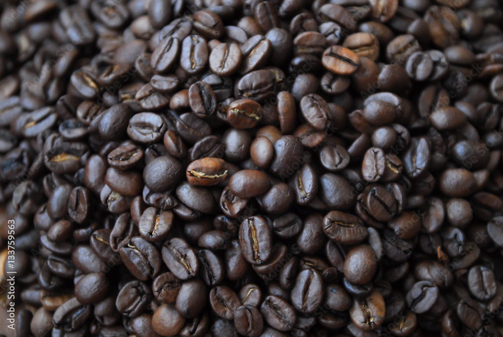 Arabica coffee beans on a black wooden table Arabica coffee beans on a black wooden table