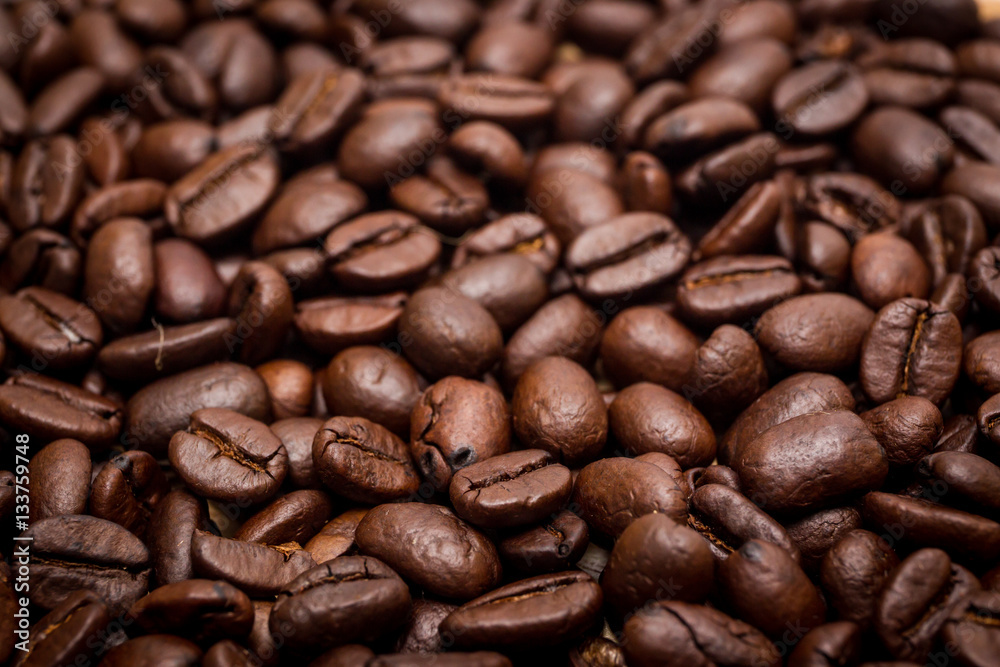 Organic coffee beans in background close up. Organic coffee beans in background close up.