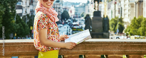 smiling young tourist woman in Prague Czech Republic with map photo