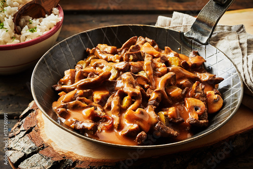 Metal skillet filled with rich beef stroganoff photo