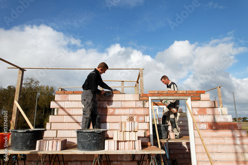 bricklayers building a wall outdoors as a professional team