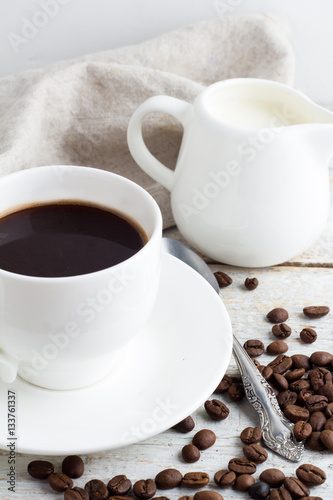 coffee in a white cup on a wooden background