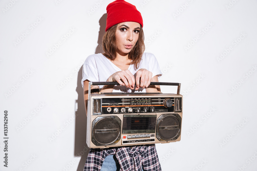 Pretty woman holding tape recorder.
