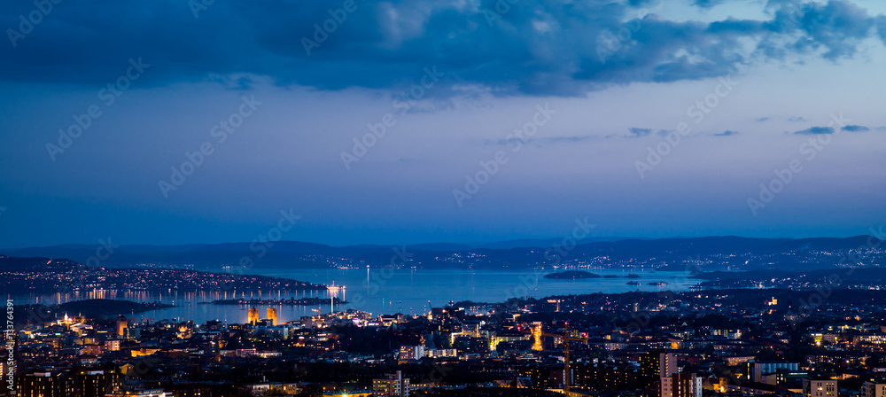View over oslo after sunset, toward the south. The Oslo fjord and the City Hall.