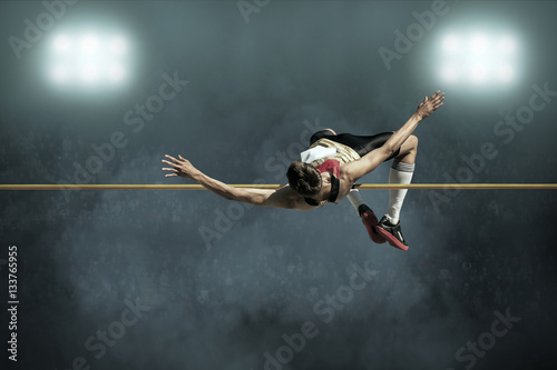Athlete in action of high jump. photo