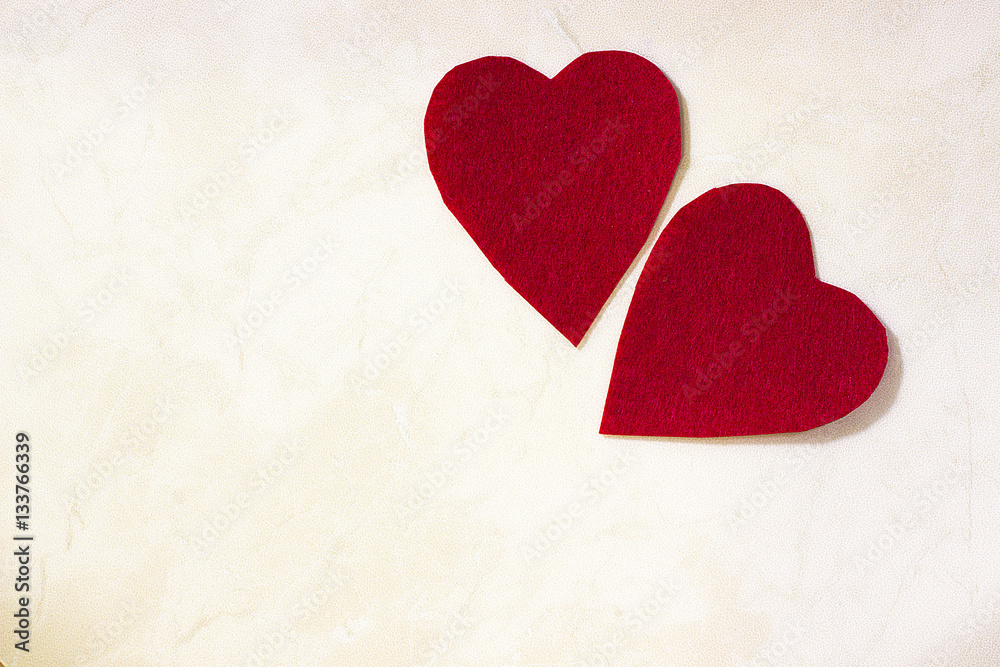 A two decorative red hearts on light background A two decorative red hearts on light background