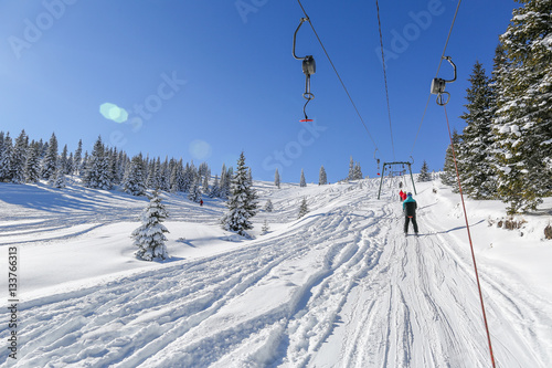 Skiers on ski lift, on a lovely sunny day in the carpathian moun