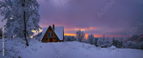 Winter mountain landscape with cottage photo