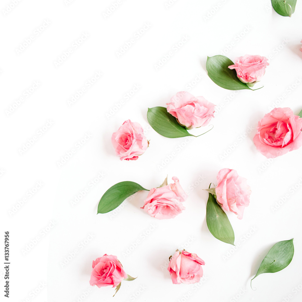 Fototapeta premium Pink roses buds on white background. Flat lay, top view. Valentine's background