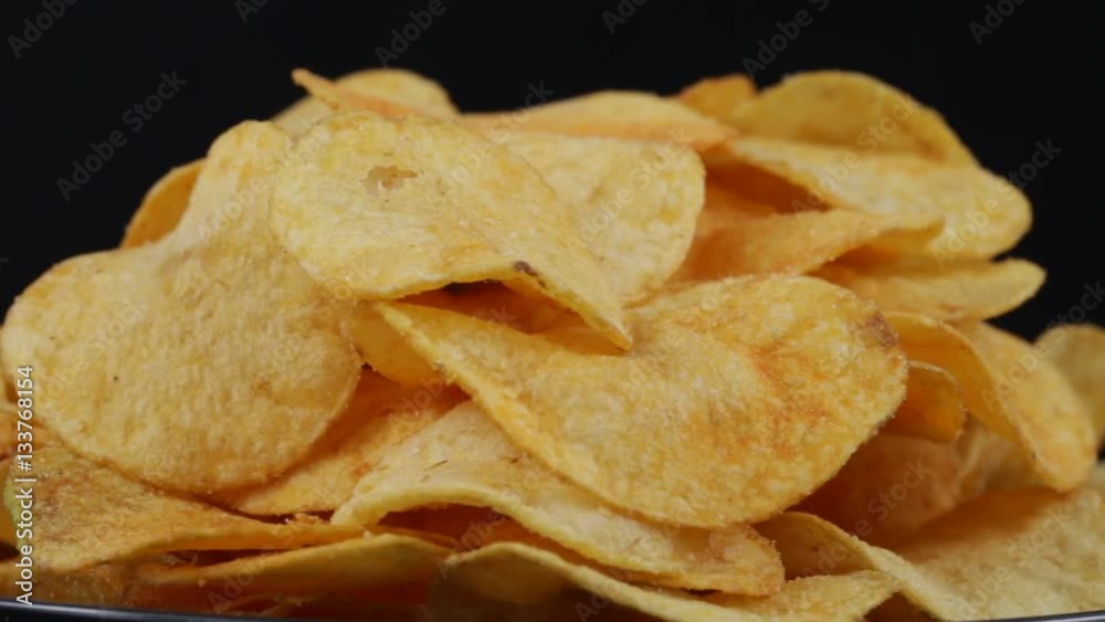 Rotating potato chips close up, macro view food background Rotating potato chips close up, macro view food background