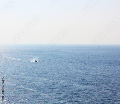 Calm blue sea and a small boat