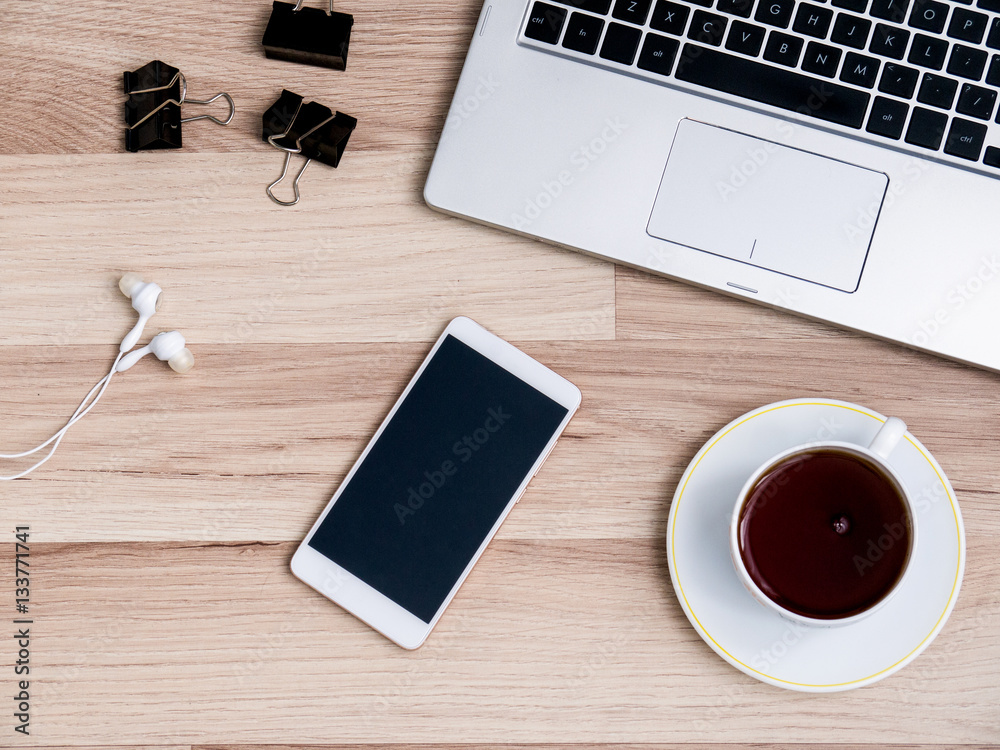 Wooden table with smartphone and Cup of tea, Desk. The view from the top Wooden table with smartphone and Cup of tea, Desk. The view from the top