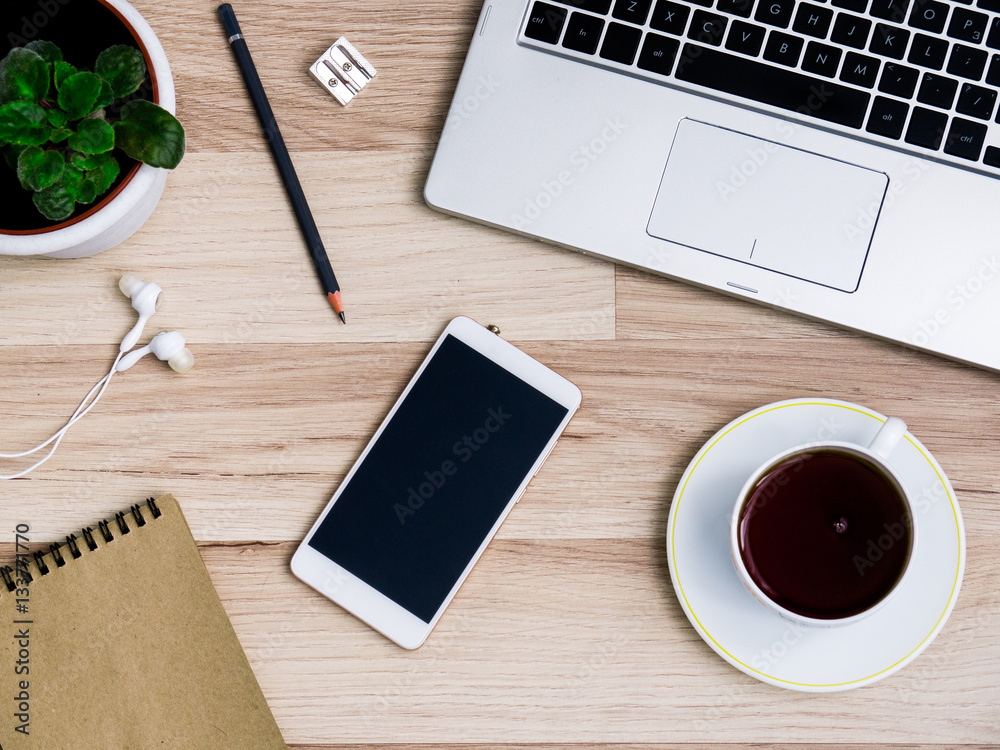 Wooden table with smartphone and Cup of tea, Desk. The view from the top Wooden table with smartphone and Cup of tea, Desk. The view from the top