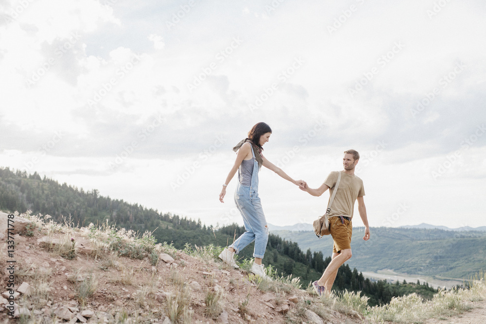 A couple in the mountains walking hand in hand. A couple in the mountains walking hand in hand.