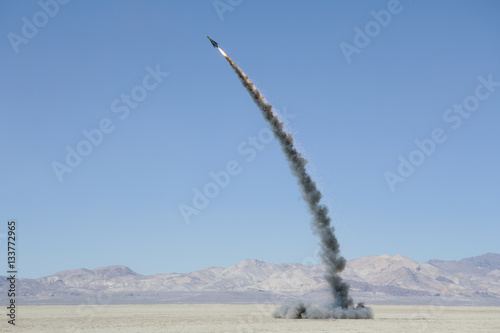 Rocket shooting into vast, desert sky, Black Rock Desert, Nevada, USA photo