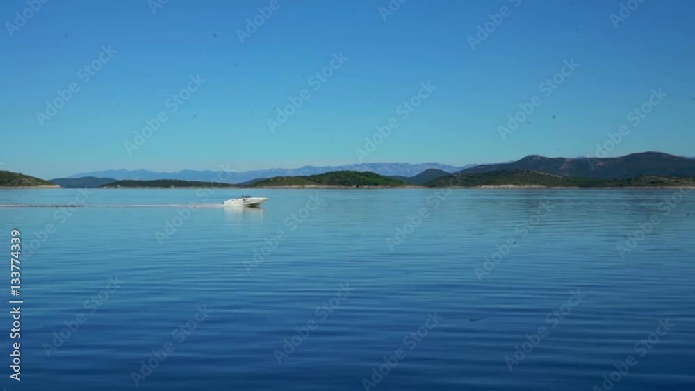 A speedboat is going very fast across the sea. There are no other ships or boats sailing on the sea. The day is gorgeous.
A speedboat is going very fast across the sea. There are no other ships or boats sailing on the sea. The day is gorgeous.