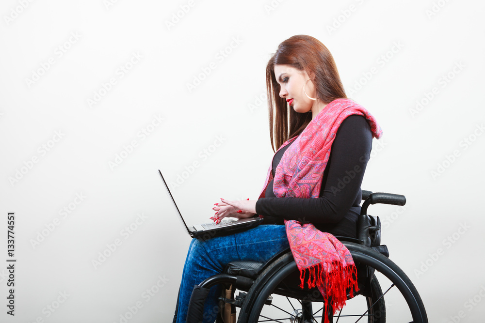 Disabled woman with laptop on wheelchair. Disabled woman with laptop on wheelchair.