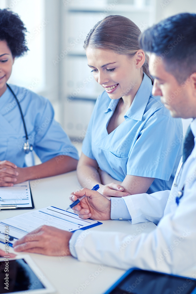 group of happy doctors meeting at hospital office group of happy doctors meeting at hospital office