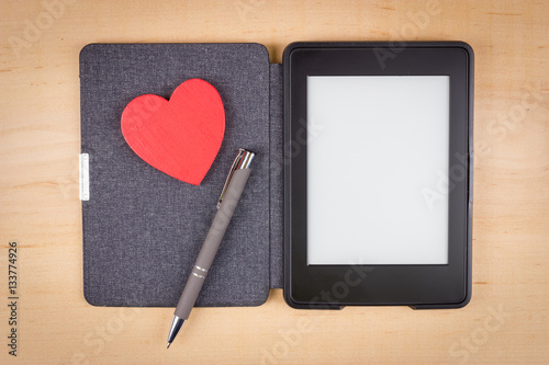 E-book reader with red heart and copy space