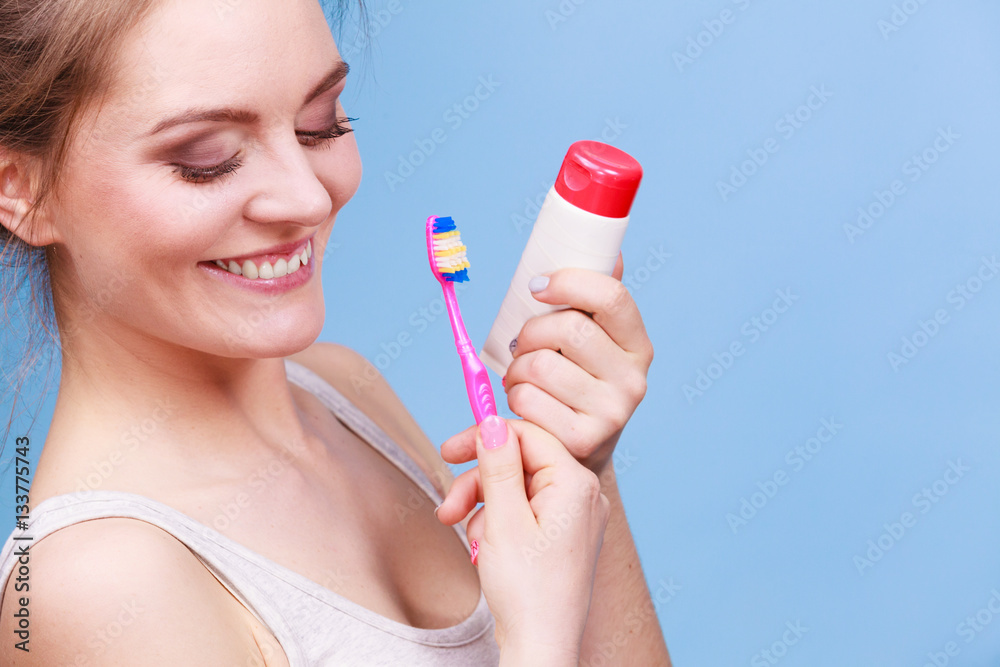 Woman holds toothbrush and paste for teeth cleaning Woman holds toothbrush and paste for teeth cleaning