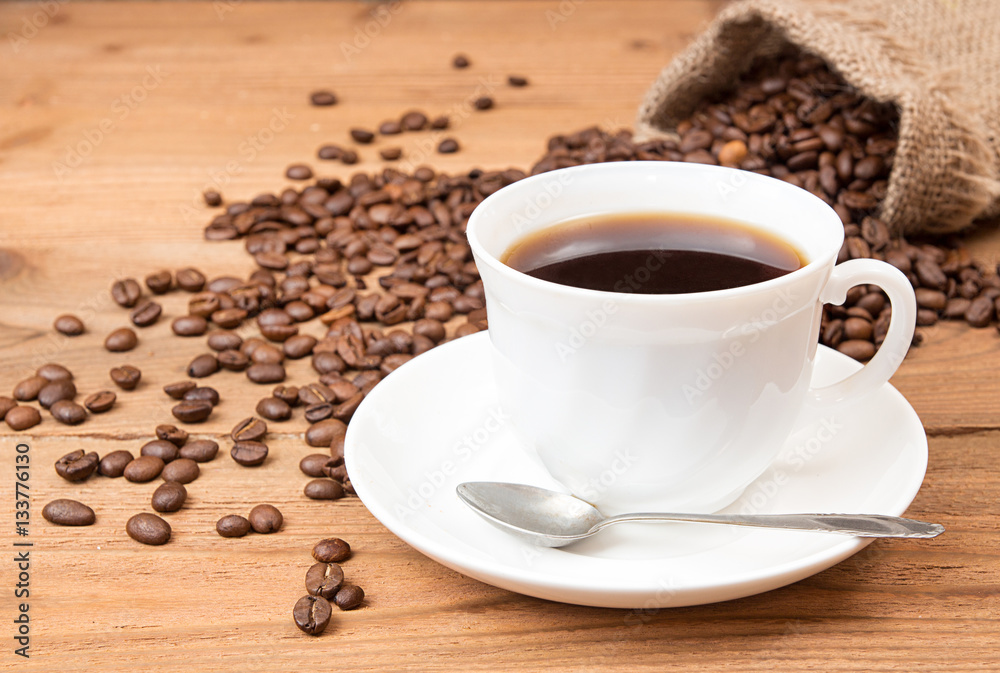 Cup of coffee, roasted coffee beans in sack