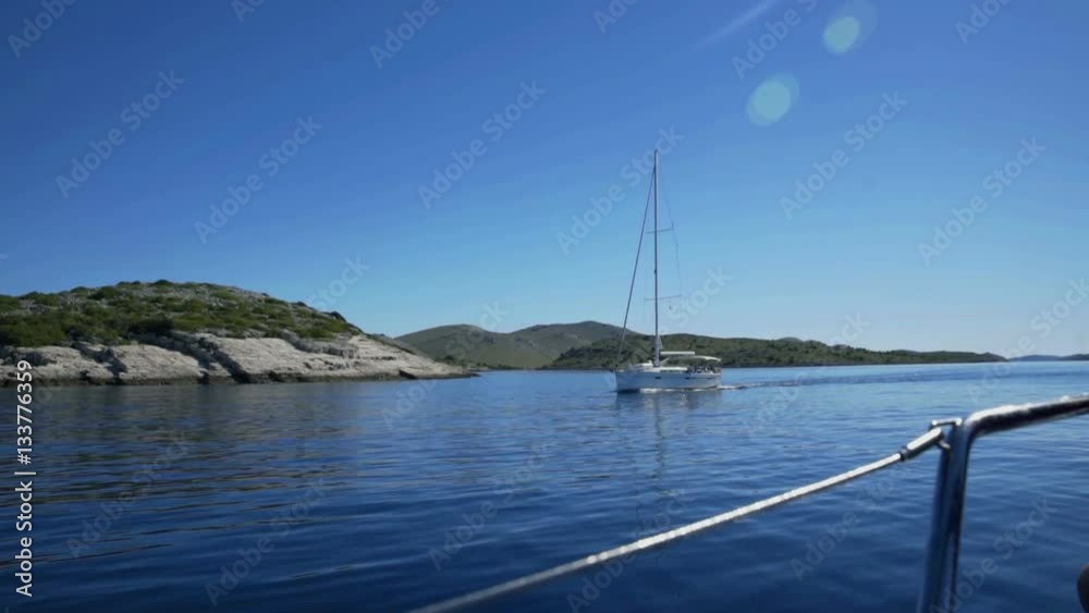 Two sailing boats are sailing in the opposite directions. The sea is peaceful and the day is wonderul and sunny.
Two sailing boats are sailing in the opposite directions. The sea is peaceful and the day is wonderul and sunny.