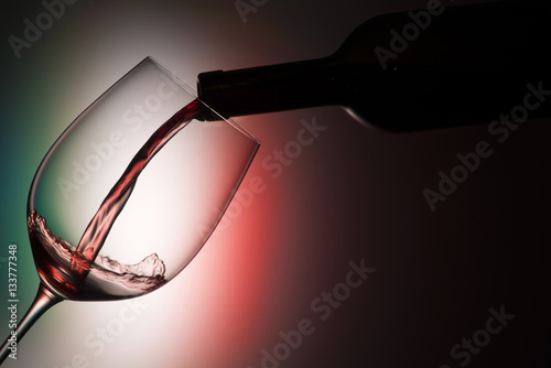 Glass with red wine on the colors of italian flag