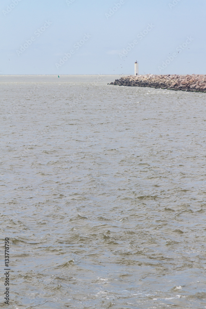 lighthouse on breakwater at Cassino beach lighthouse on breakwater at Cassino beach