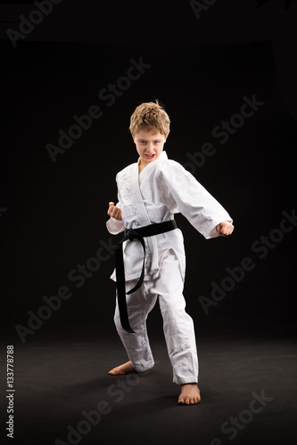 black belt karate blond kid isolated on black