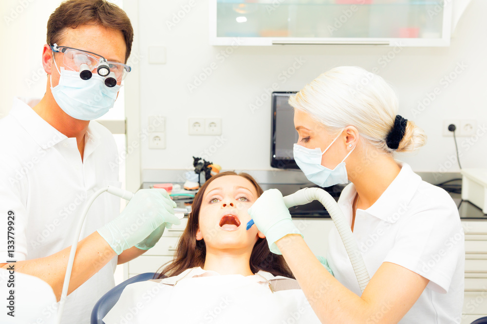Young Woman Getting A Treatment At The Dentist Young Woman Getting A Treatment At The Dentist