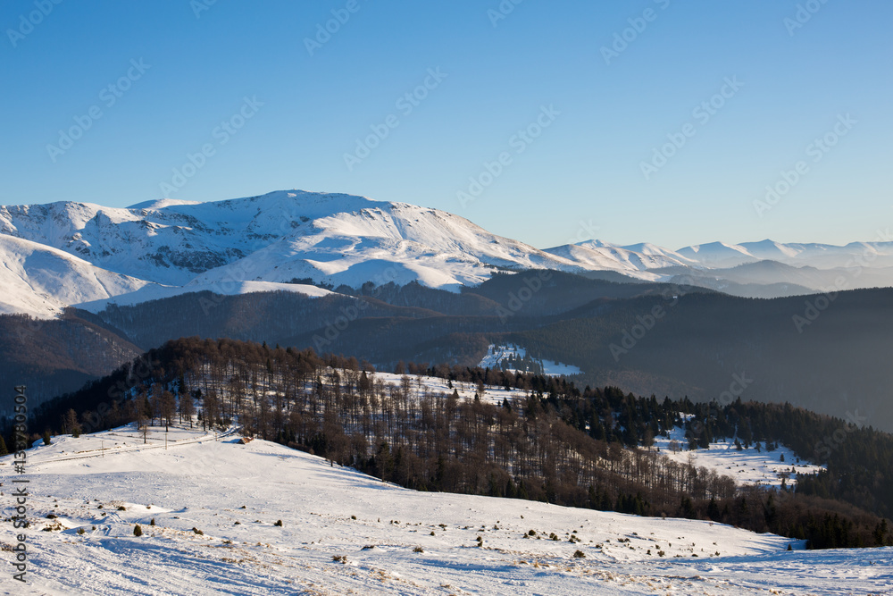 Sunset in the winter, snowy mountains and ski