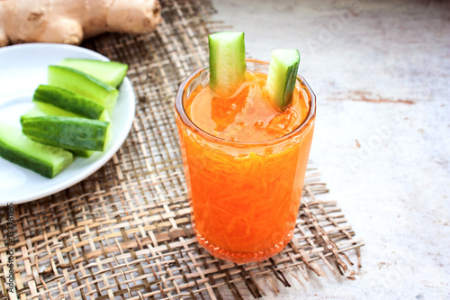 carrot juice in a glass on a wooden table selective focus