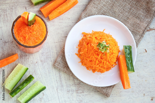 carrots salad and carrot juice with pulp and a cucumber selectiv