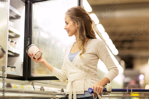 woman with ice cream at grocery store freezer photo
