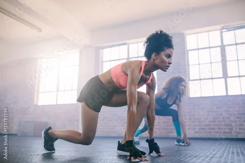 Obraz Młode kobiety robi treningowi w gym wpólnie.