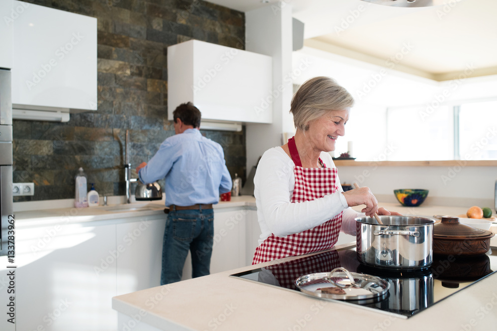 Senior couple in the kitchen cooking together. Senior couple in the kitchen cooking together.
