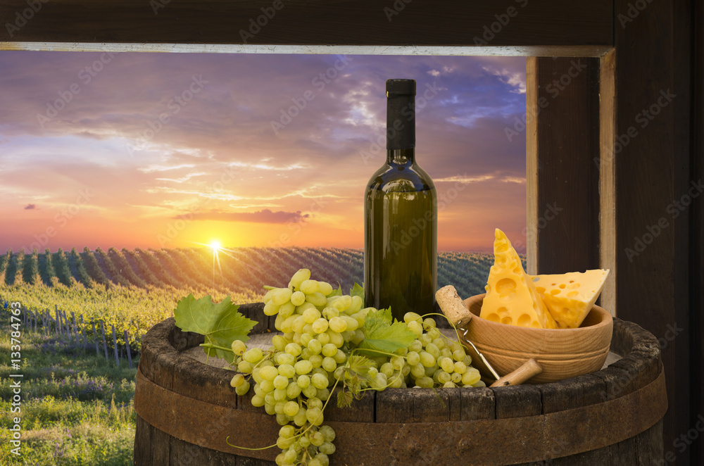 Fototapeta premium Red wine with barrel on vineyard in green Tuscany, Italy