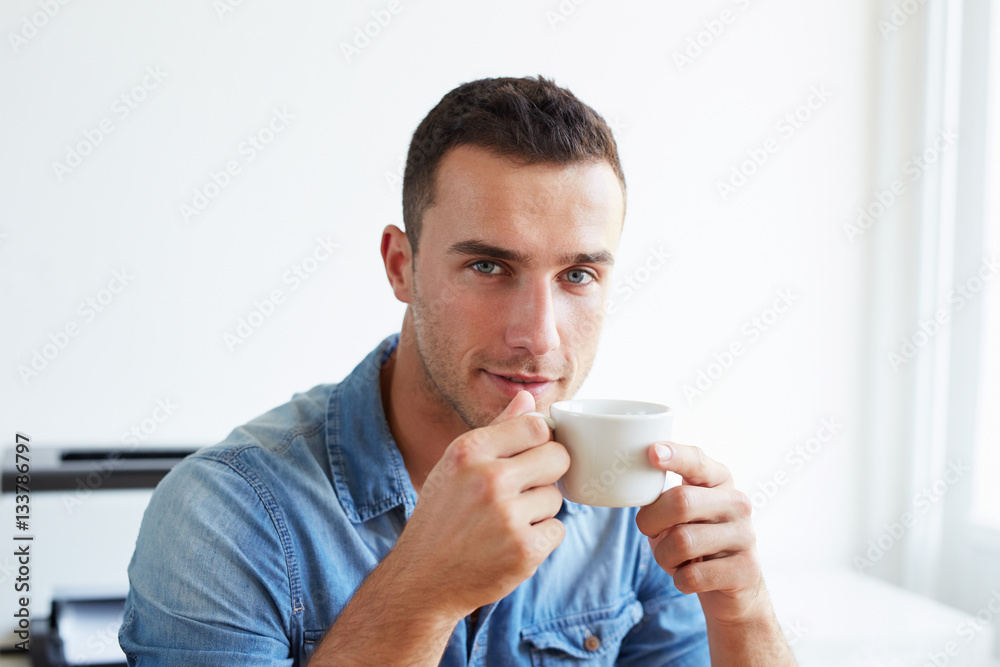 Man in the office with coffee cup Man in the office with coffee cup