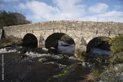 The East Dart River and road bridge built in the 1700's at Postbridge on Dartmoor in Devon England UK. January 2017