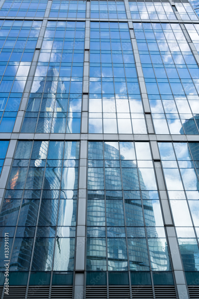 skyscrapers of steel and glass reflected in buildings facade skyscrapers of steel and glass reflected in buildings facade
