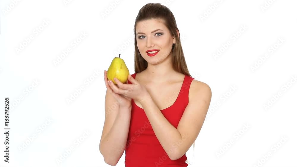 woman with red lips holding juicy pear and smilin
