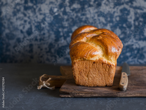 Homemade brioche on a dark background. Front view. Delicious pastries